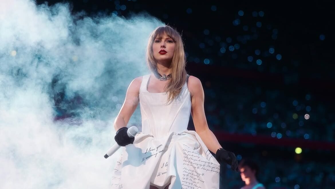 Taylor Swift performing live during a global music concert in 2026